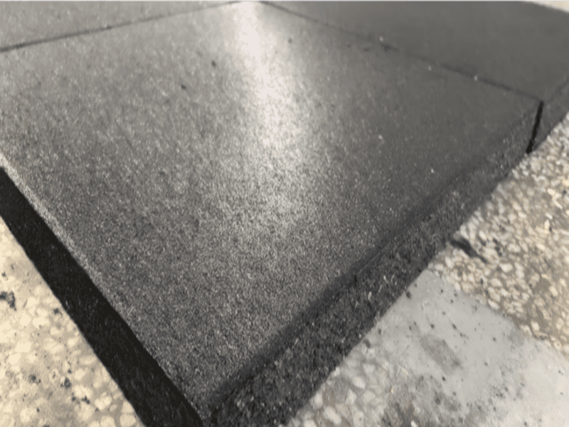 Testing rubber gym tiles with different cleaning agents to diagnose surface stains